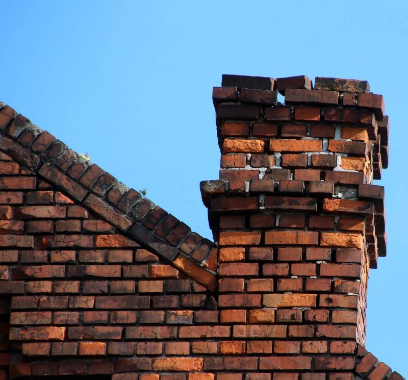 Damaged chimney on an Tinley Park home showing cracks and missing mortar